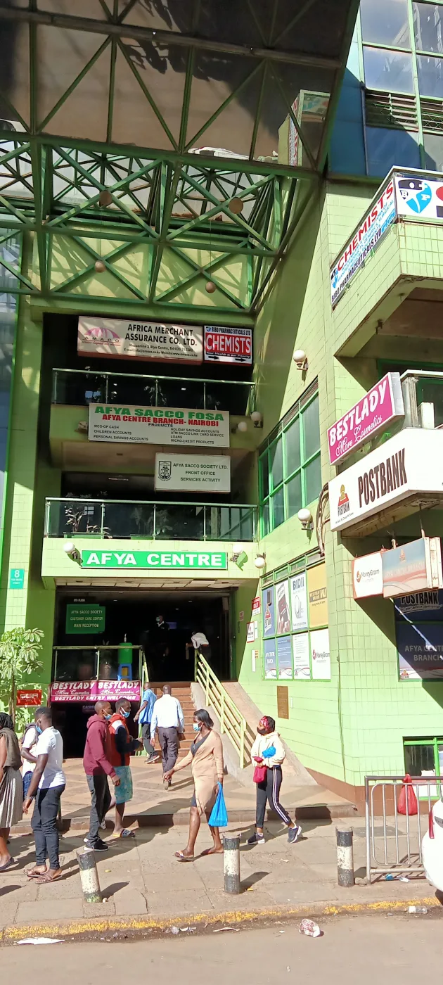 Multi-tenant building fascia carrying stacked business signboards on a busy street