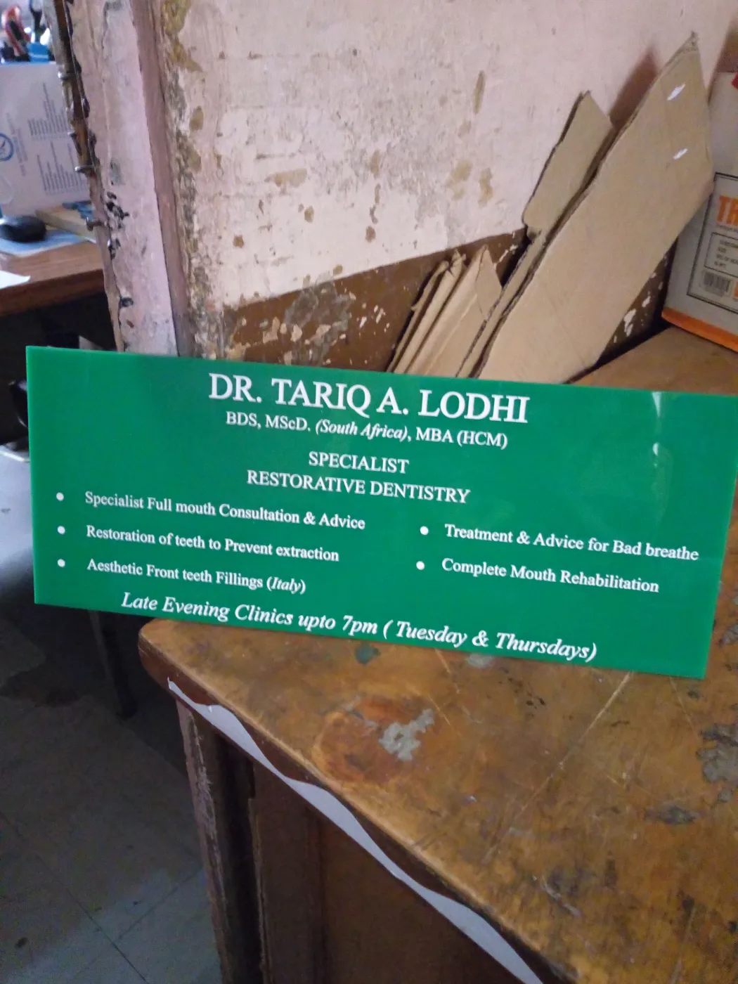 Clinic information signboard listing services and consulting hours