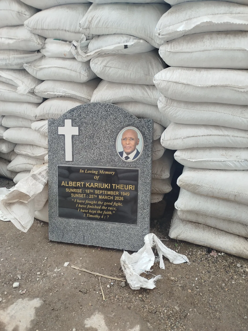 Full granite headstone with a carved cross and engraved inscription panel